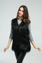 Woman in a black faux fur vest, front view with arms outstretched