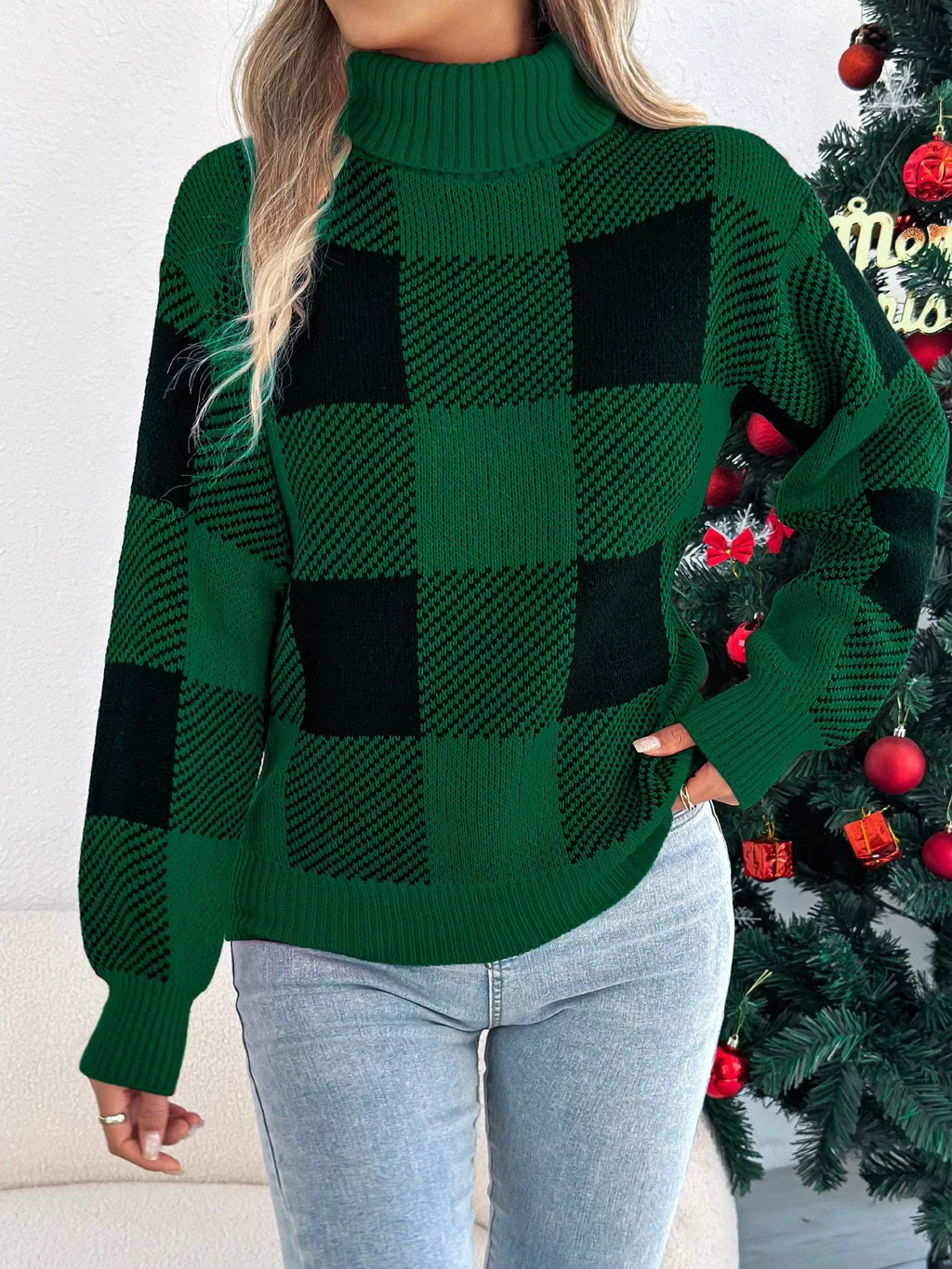 Woman adjusting her green and black buffalo plaid turtleneck sweater.