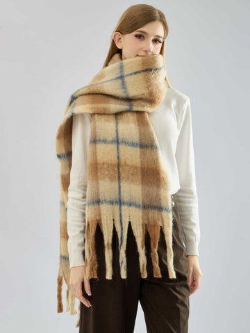 Model wearing a beige and blue plaid scarf draped around her neck