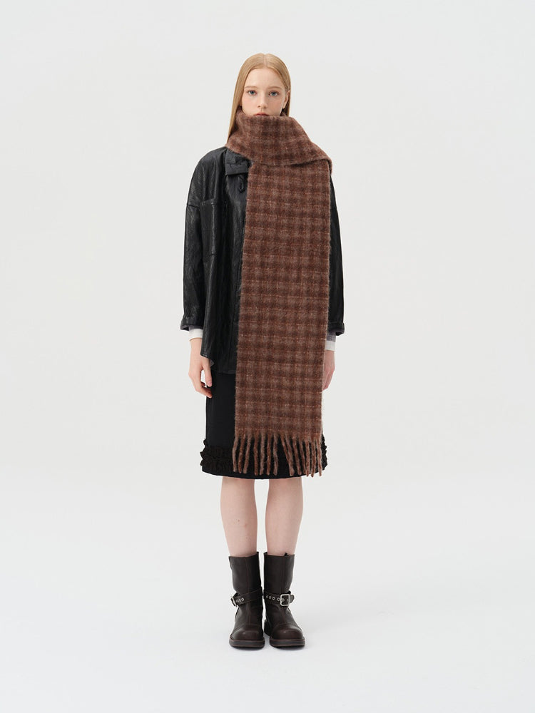 Woman wearing a brown tartan scarf with fringe details Main image