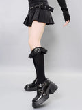Detailed view of gothic-inspired black socks with decorative trim.