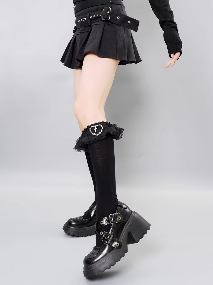 Detailed view of gothic-inspired black socks with decorative trim.