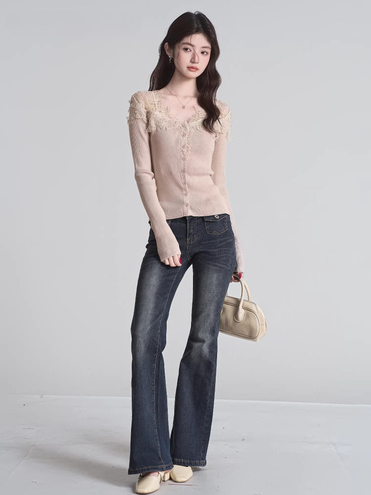 Full body shot of a woman wearing a beige fitted ribbed knit cardigan with lace trim and button-down front, paired with dark wash flare jeans