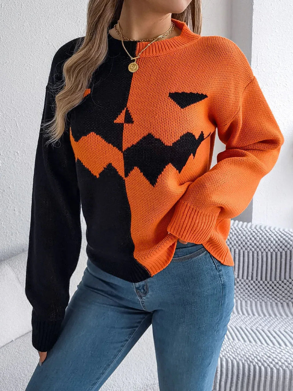 Close-up of the front of the black and orange knitted sweater with jack-o'-lantern design.