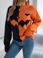 Close-up of the front of the black and orange knitted sweater with jack-o'-lantern design.