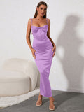Woman wearing a lavender satin midi dress with a corset bodice and spaghetti straps.