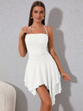 Front side view of a woman in a white ruched halter neck mini dress with an asymmetrical tiered skirt.