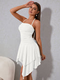 Woman posing in a white ruched halter neck mini dress with an asymmetrical tiered skirt.