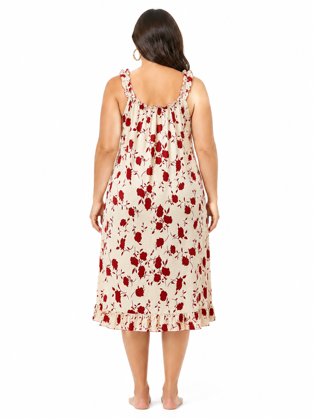Back view of a woman in a cream and red floral print nightgown.