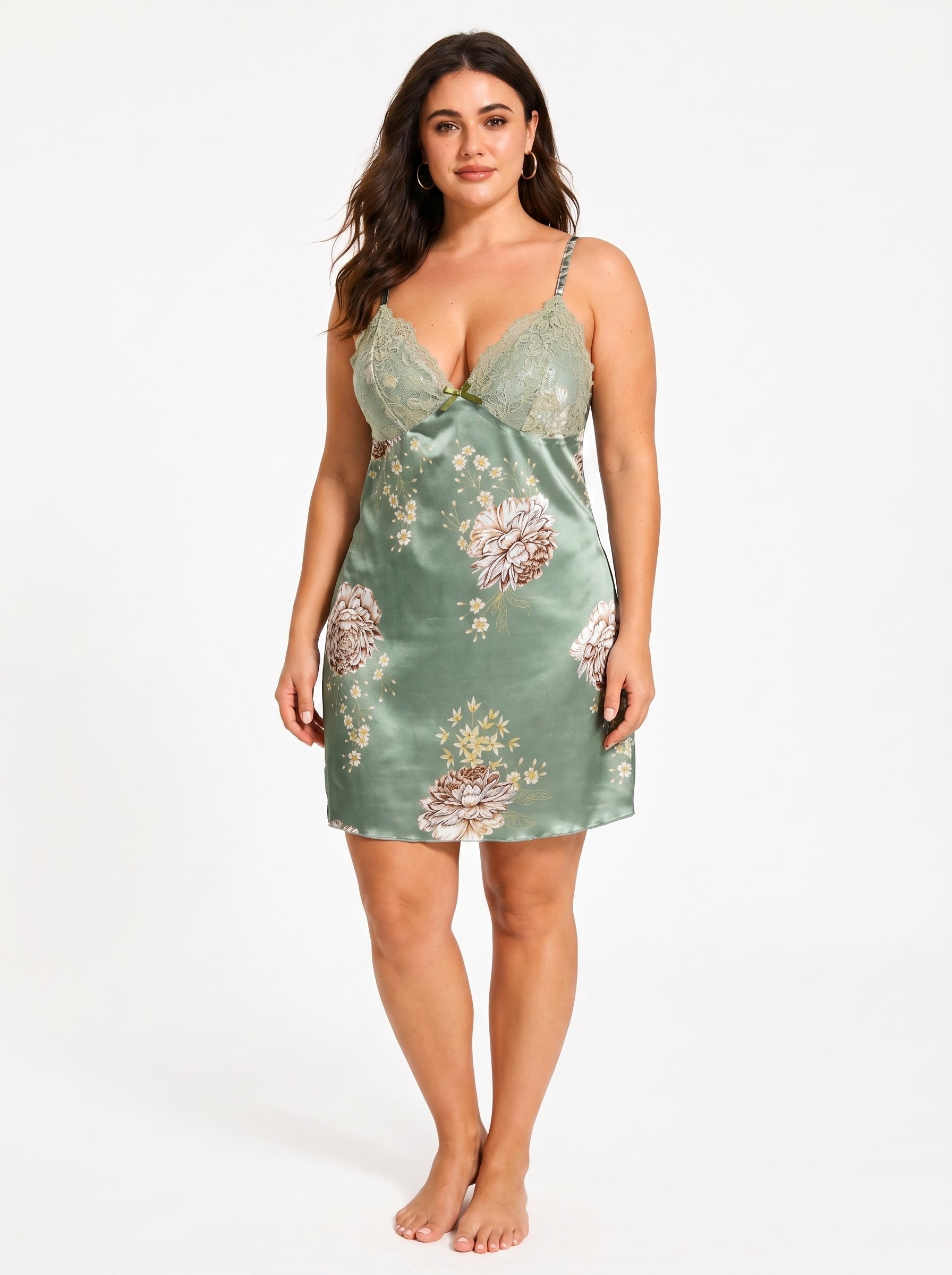 Woman in a green satin floral print slip dress with lace details