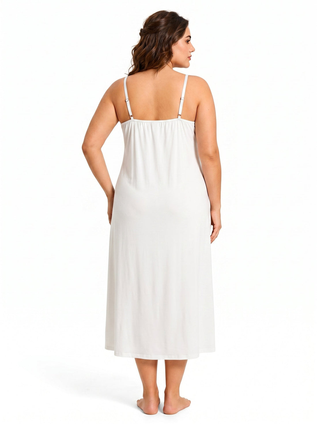 Woman wearing a white robe with black lace trim over a white slip dress with black lace top