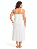 Rear view of a woman wearing a white slip dress