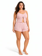 Front view of a woman modeling a pink cami and shorts pajama set