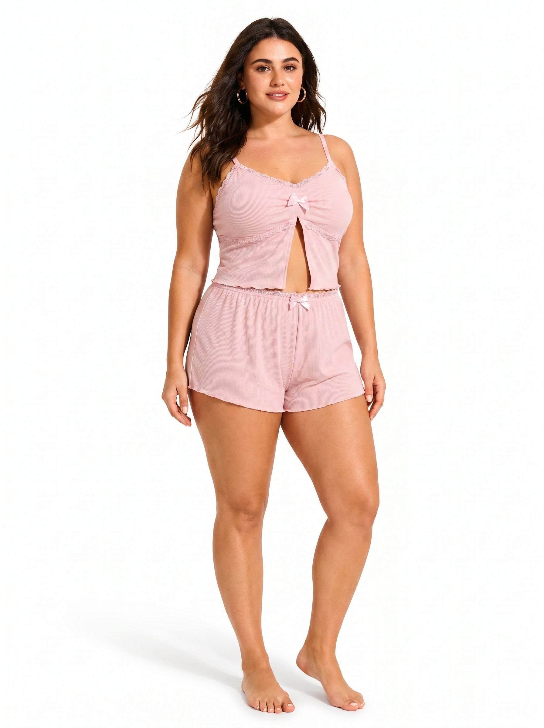 Front view of a woman modeling a pink cami and shorts pajama set