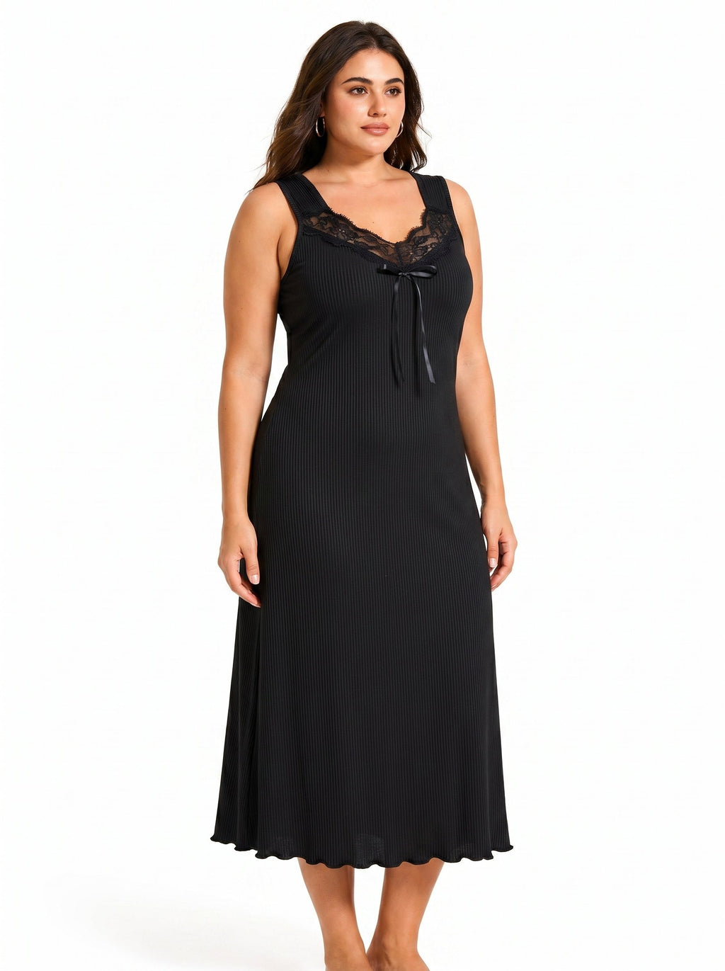 Plus-size model posing in a black ribbed knit nightgown with lace neckline
