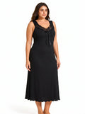 Plus-size model posing in a black ribbed knit nightgown with lace neckline