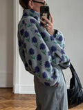 Back view of a woman in a patterned fleece pullover with a stand collar.
