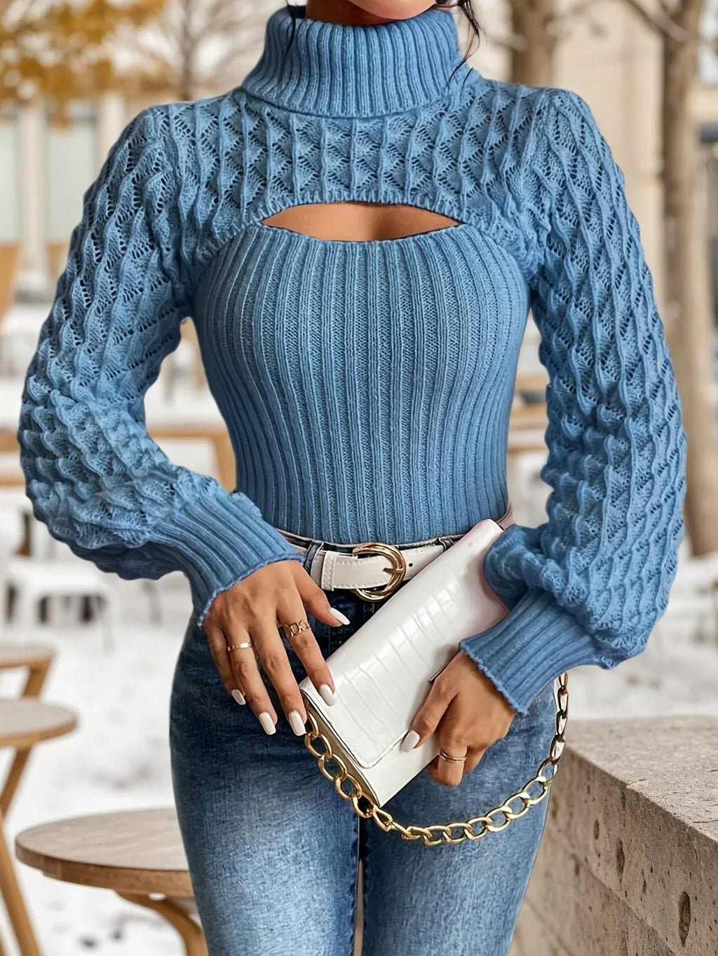 Front close-up of a woman wearing a blue cutout turtleneck sweater