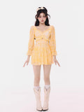 Full length shot of a woman in a yellow tie-dye mini dress.