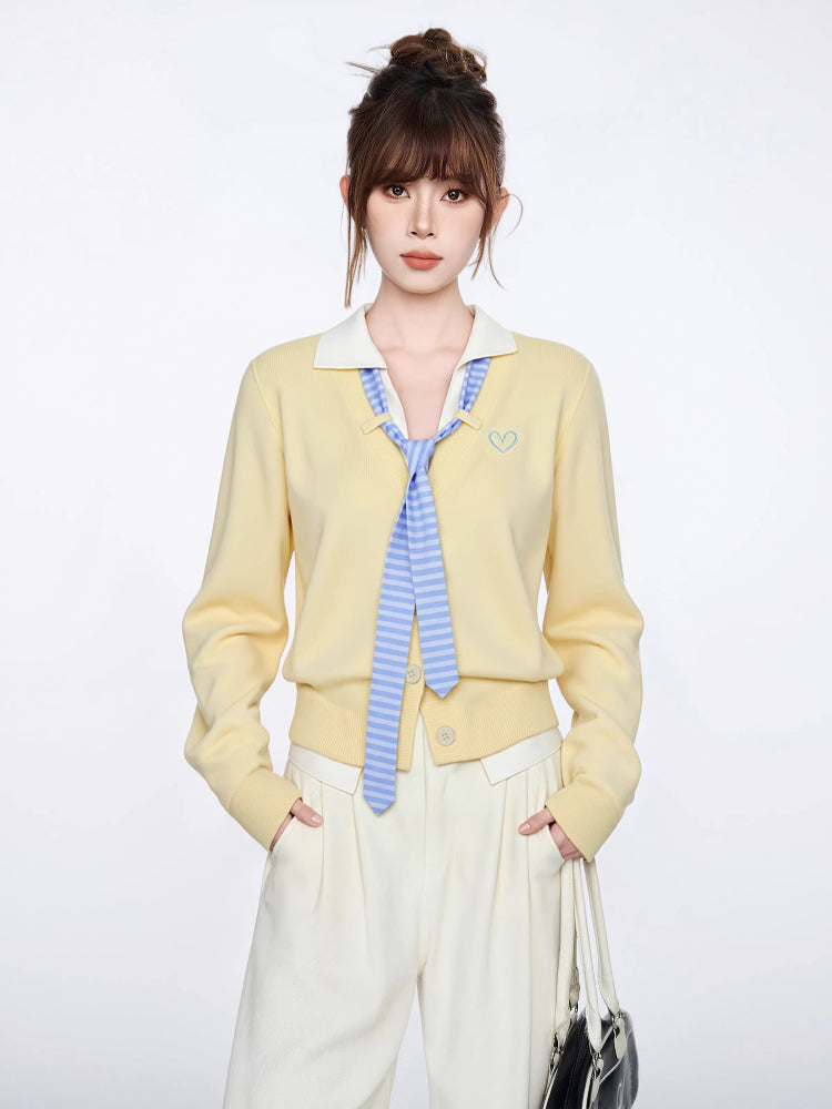 Woman wearing a pastel yellow knit cardigan with a white collar and blue striped tie