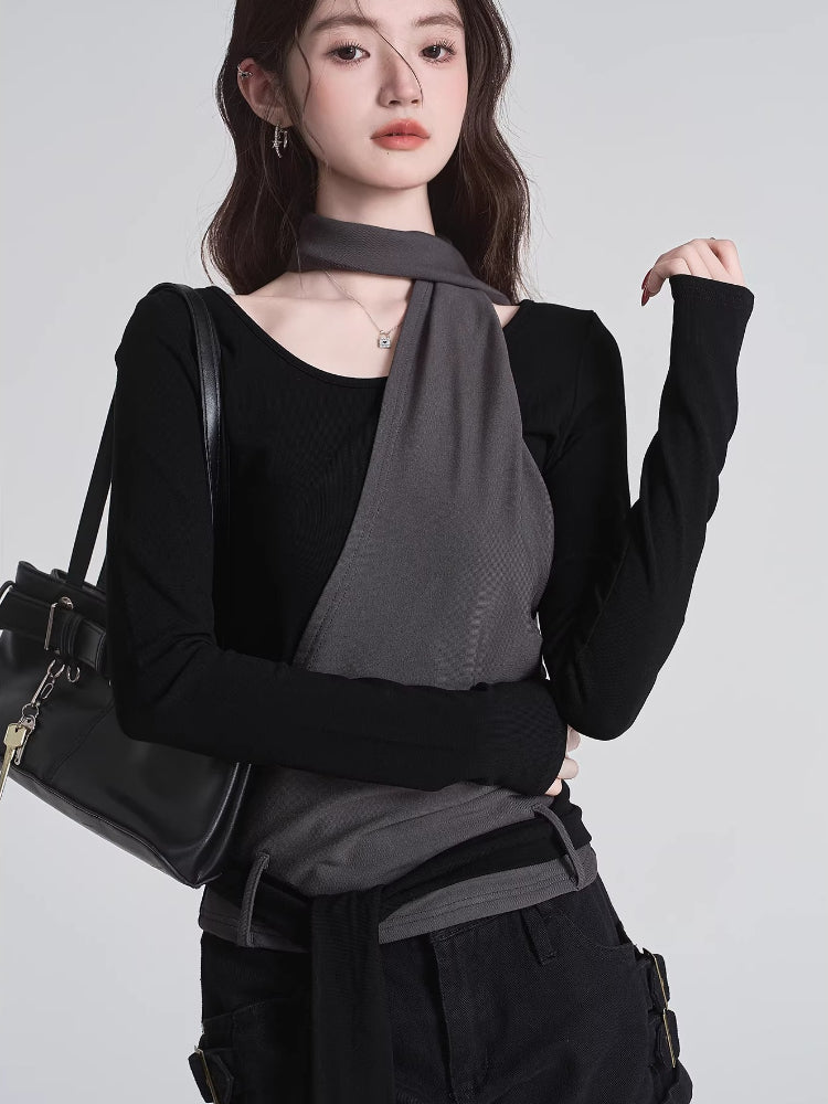 Woman posing with a black handbag, showcasing the black top with grey overlay