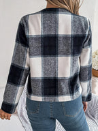 Back view of a woman wearing a blue and white plaid jacket.