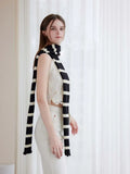 Model styling a monochrome striped scarf