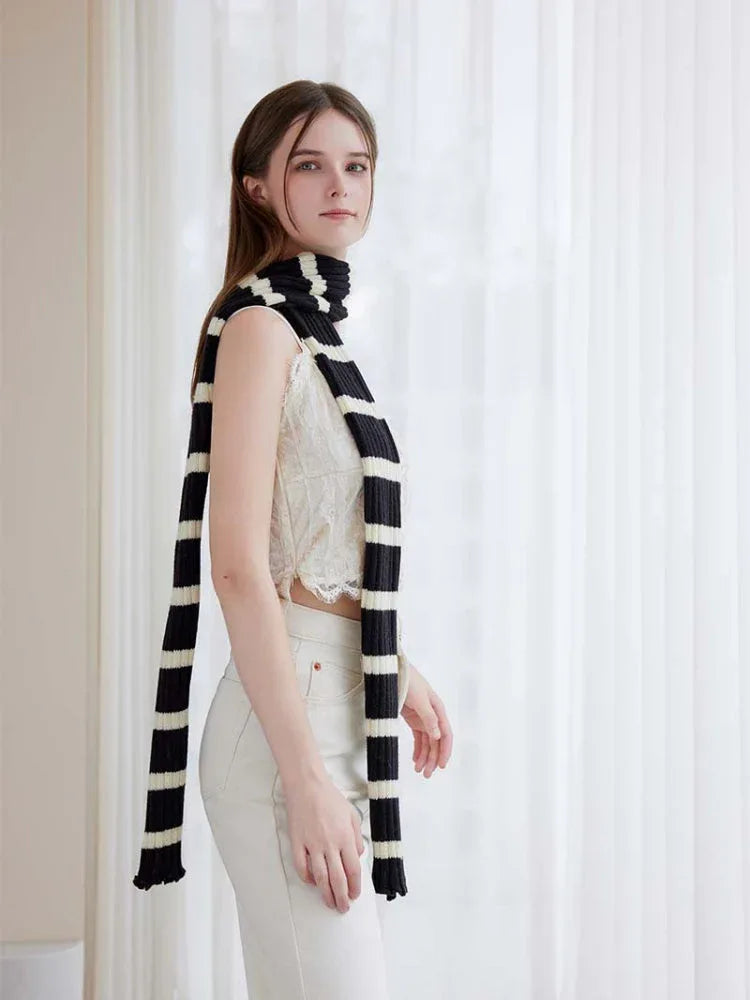 Model styling a monochrome striped scarf