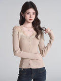 Beige fitted ribbed knit cardigan with lace trim and button-down front