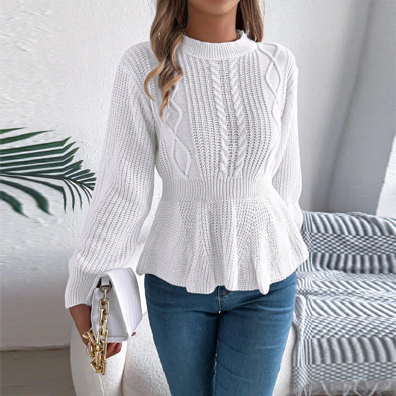 Woman wearing a white long-sleeved knit peplum sweater with cable knit detailing and a mock neckline.