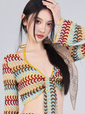 Close-up of the woman's face and the intricate crochet knit pattern of the top