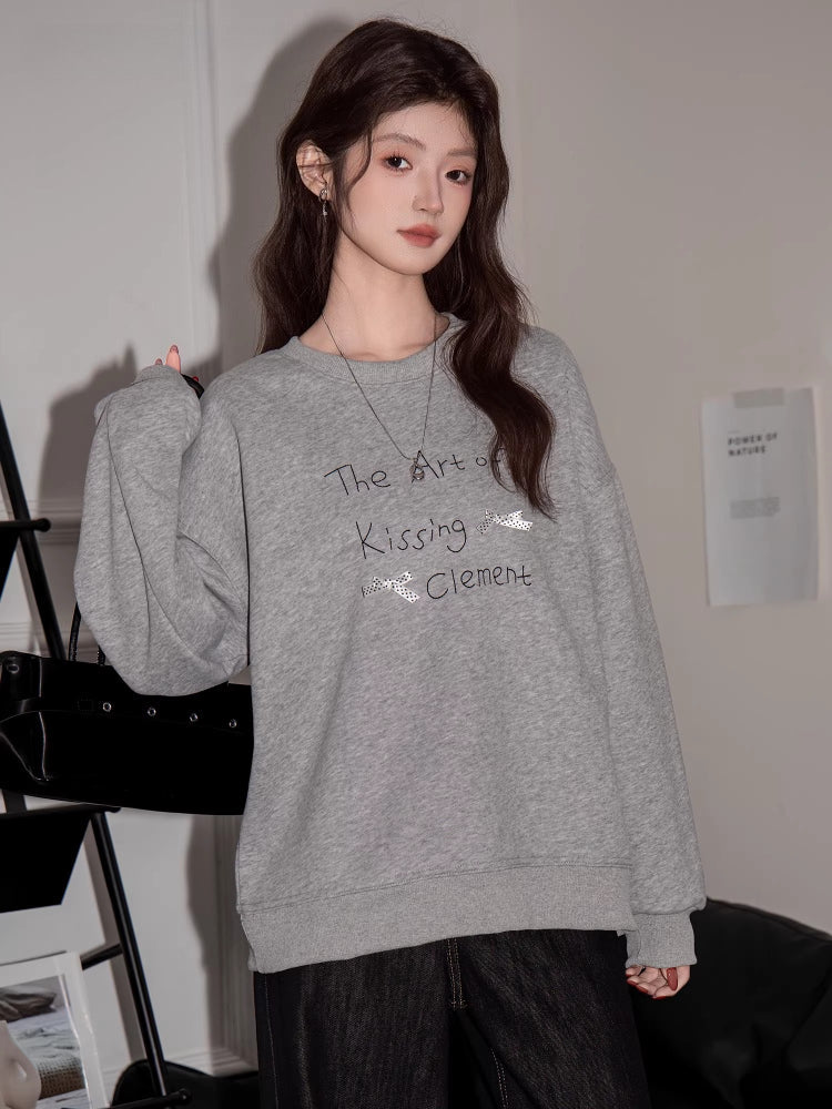 Casual grey sweatshirt featuring a printed design on the chest.