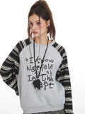 Detailed view of the graphic print on a model's sweatshirt.