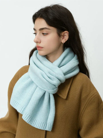 Woman wearing a light blue knit scarf