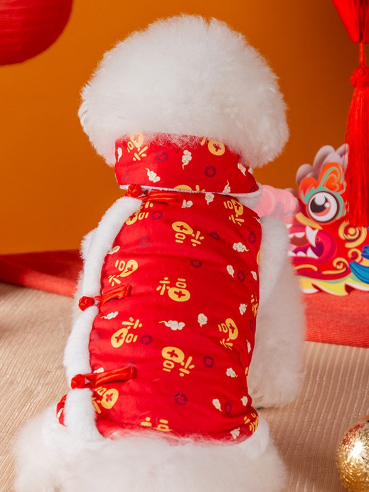 Bichon Frise dog wearing a red festive pet vest with white faux fur trim and Chinese knot buttons