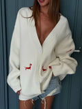 Cream oversized knit cardigan with red embroidered dachshunds and button front