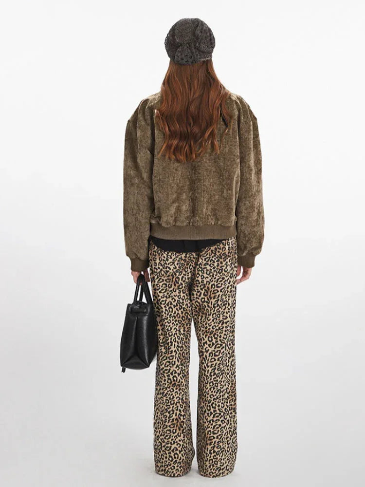 Back view of a woman in a brown crushed velvet bomber jacket and leopard print pants