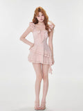 Full body shot of a woman wearing a pink tiered dress