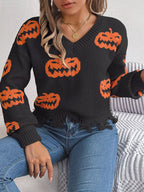 Close-up of distressed hem on pumpkin knit sweater