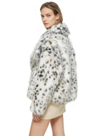 Back view of a woman in a faux fur leopard print cropped jacket