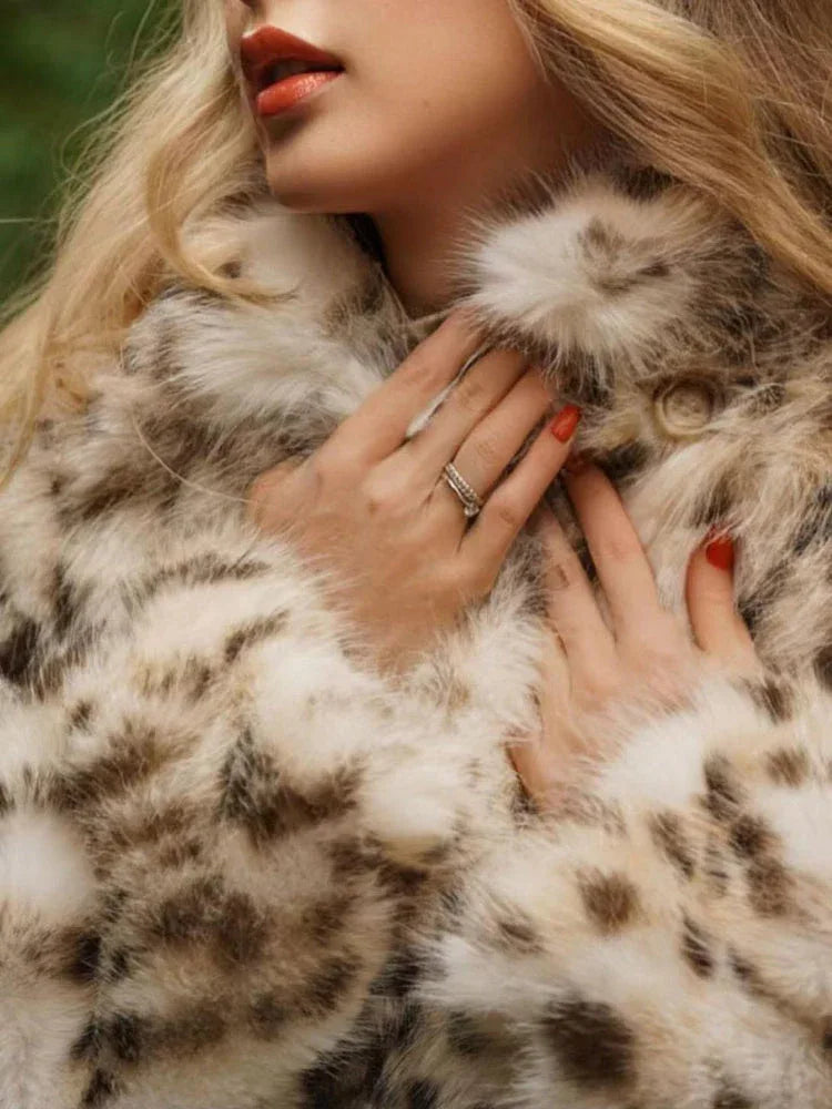 Close-up of a woman's hands on a spotted faux fur coat