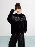 Close-up of the Fair Isle snowflake pattern on a black knit hoodie