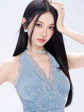 Close-up of the light blue lace dress showing the V-neckline and ruffled trim.