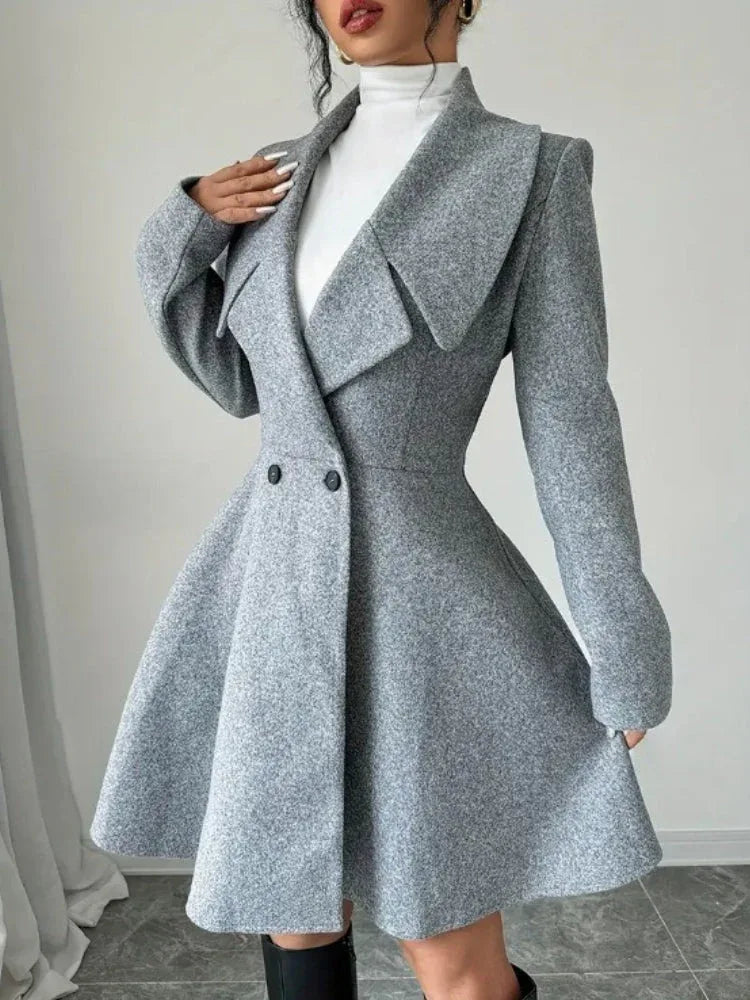 Woman wearing a grey fit-and-flare wool blend tweed coat with a wide lapel collar and double-breasted closure. Main image