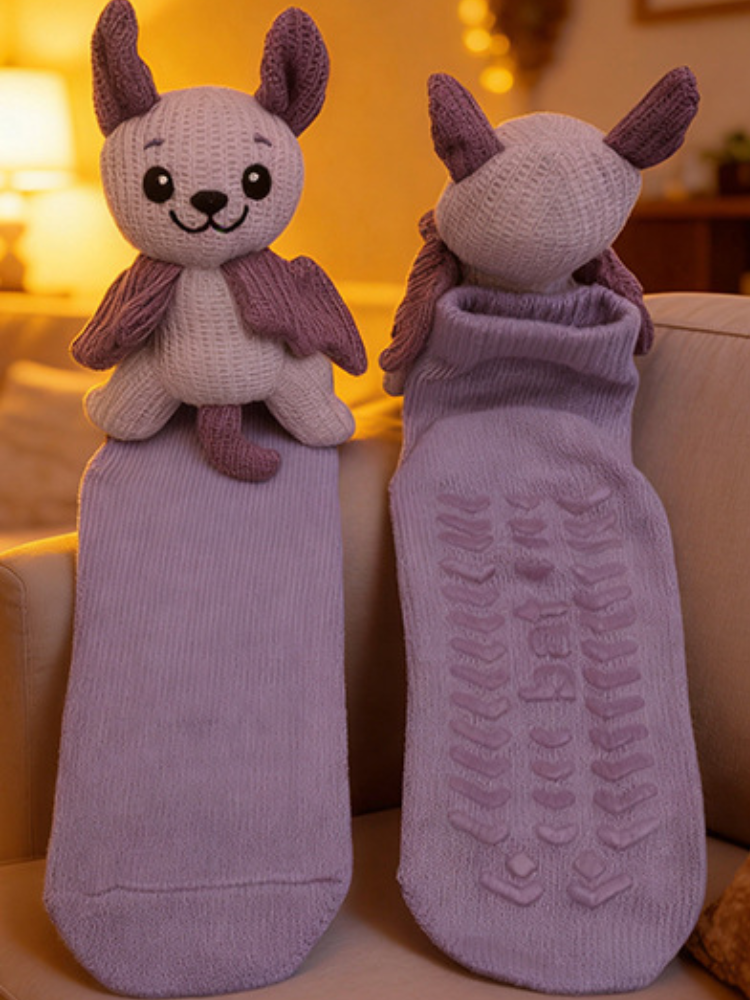 Light purple ankle sock with a light purple and darker purple knitted bat character applique attached to the cuff.