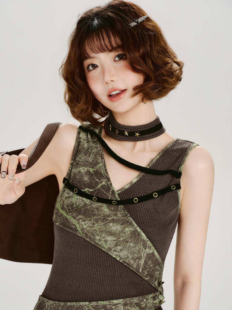 Model winking while wearing the tank top and a star-embellished choker