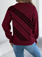 Back view of a woman wearing a maroon knit sweater with black diagonal stripes.