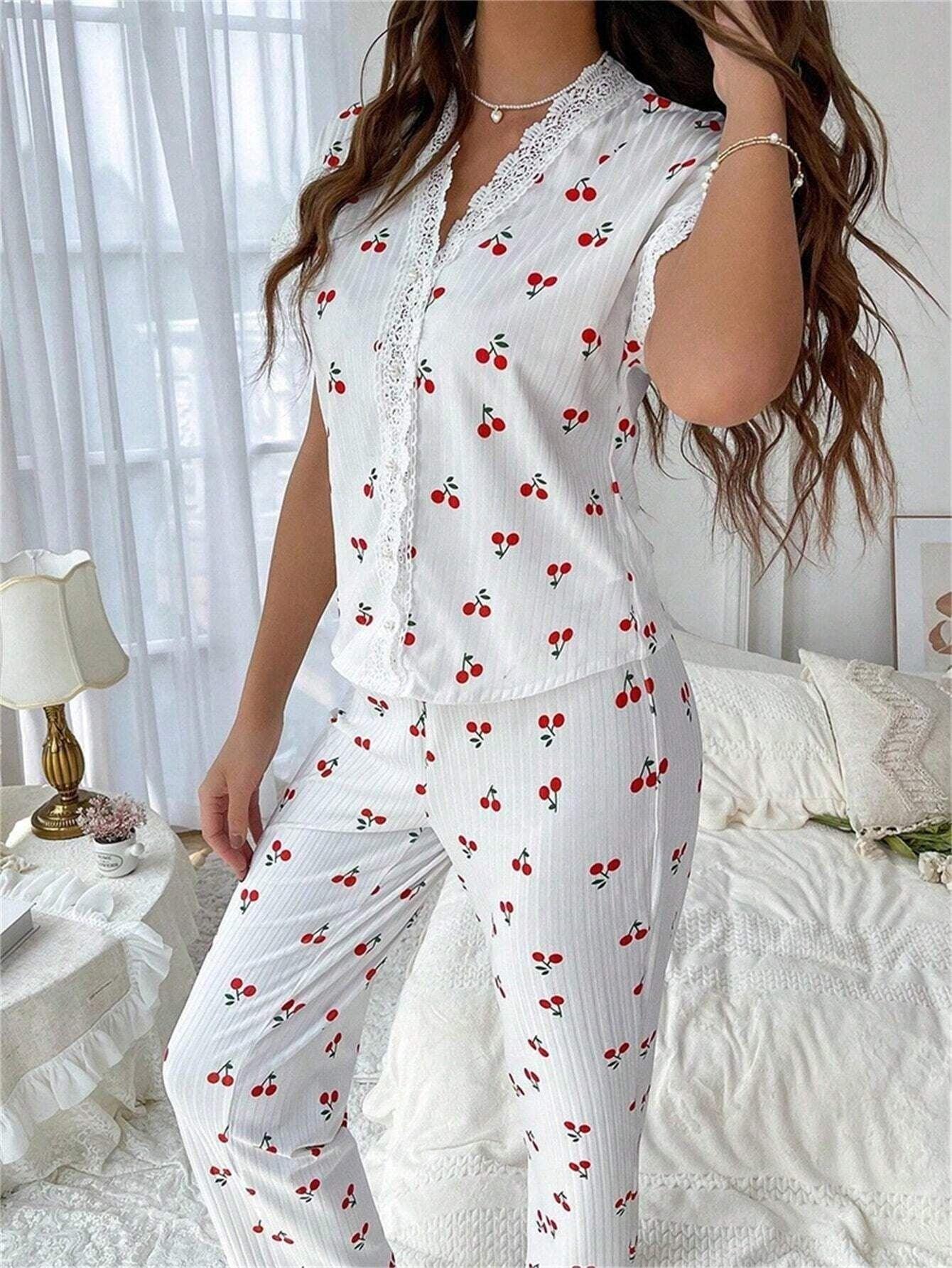 Side view of a woman in a white cherry print pajama set with lace accents.