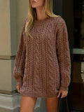Front view of a woman in a brown cable knit sweater dress
