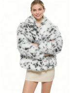 Woman smiling in a faux fur leopard print jacket